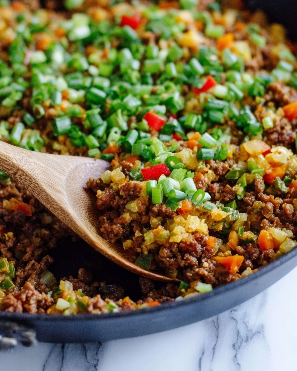 A close-up of a cooked dish in a black pan showing four main layers: the bottom layer is finely browned ground meat mixed with small bits of cooked vegetables, which looks crumbly and rich brown; the middle layer consists of small orange and yellow diced vegetables, offering a soft and slightly shiny texture; the top layer is brightly colored with chopped green onions and small red pieces, giving a fresh and crunchy look; a wooden spoon is scooping into the dish, showing an inviting mix of all layers. The background is a white marbled texture. Photo taken with an iphone --ar 4:5 --v 7